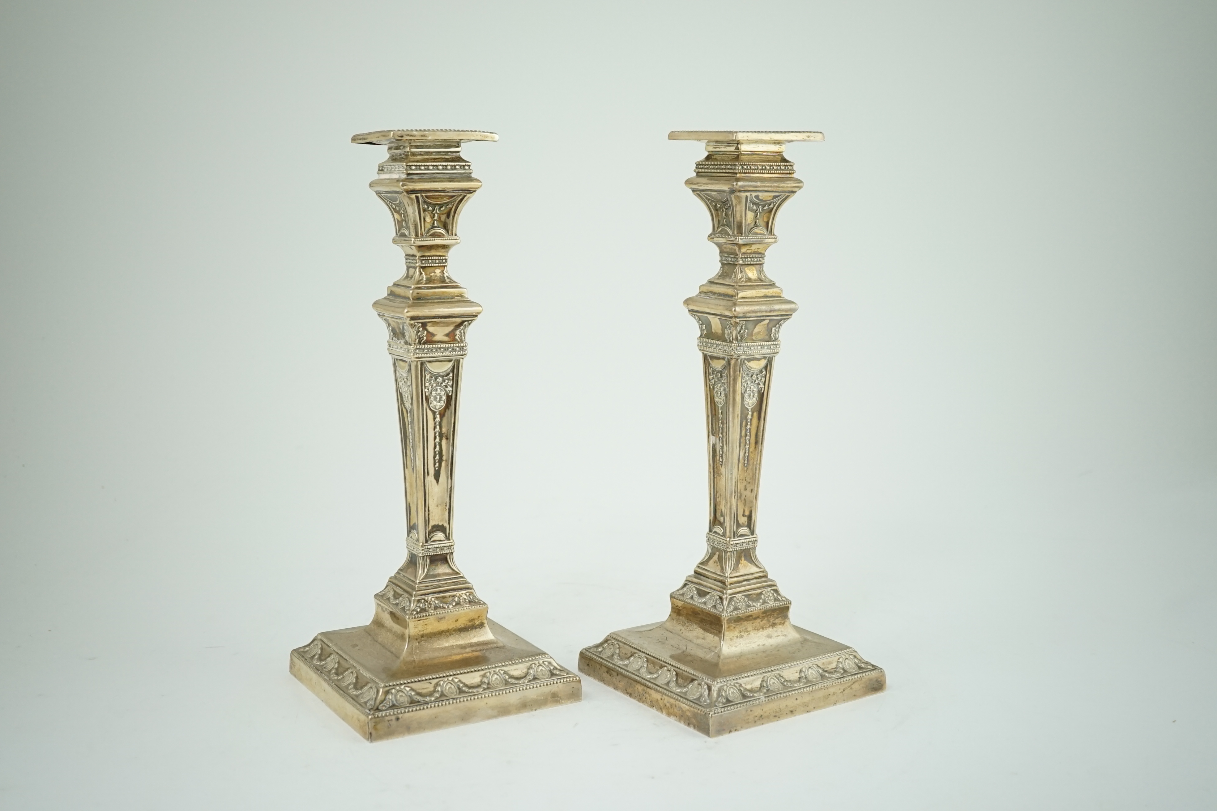 A pair of Edwardian Adam revival silver candlesticks, by Walker & Hall